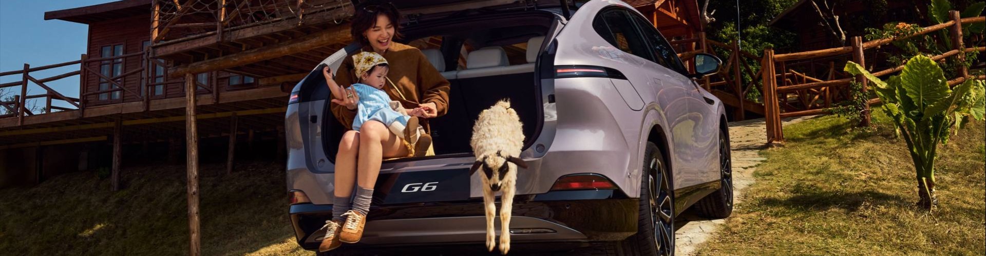 Purple XPENG G6 with family