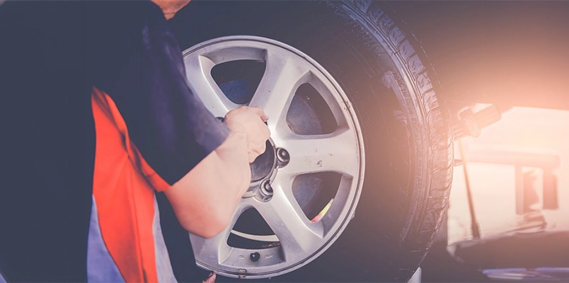 Mechanic working on car wheel