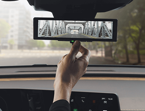 Someone adjusting their rearview mirror