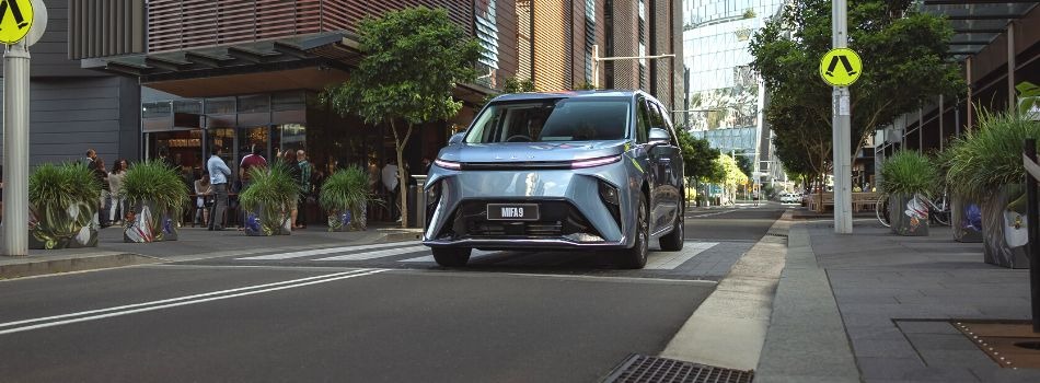 A blue LDV MIFA 9 driving down a backstreet