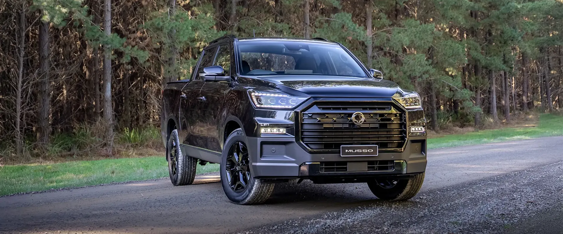 KGM Musso parked on a gravel road