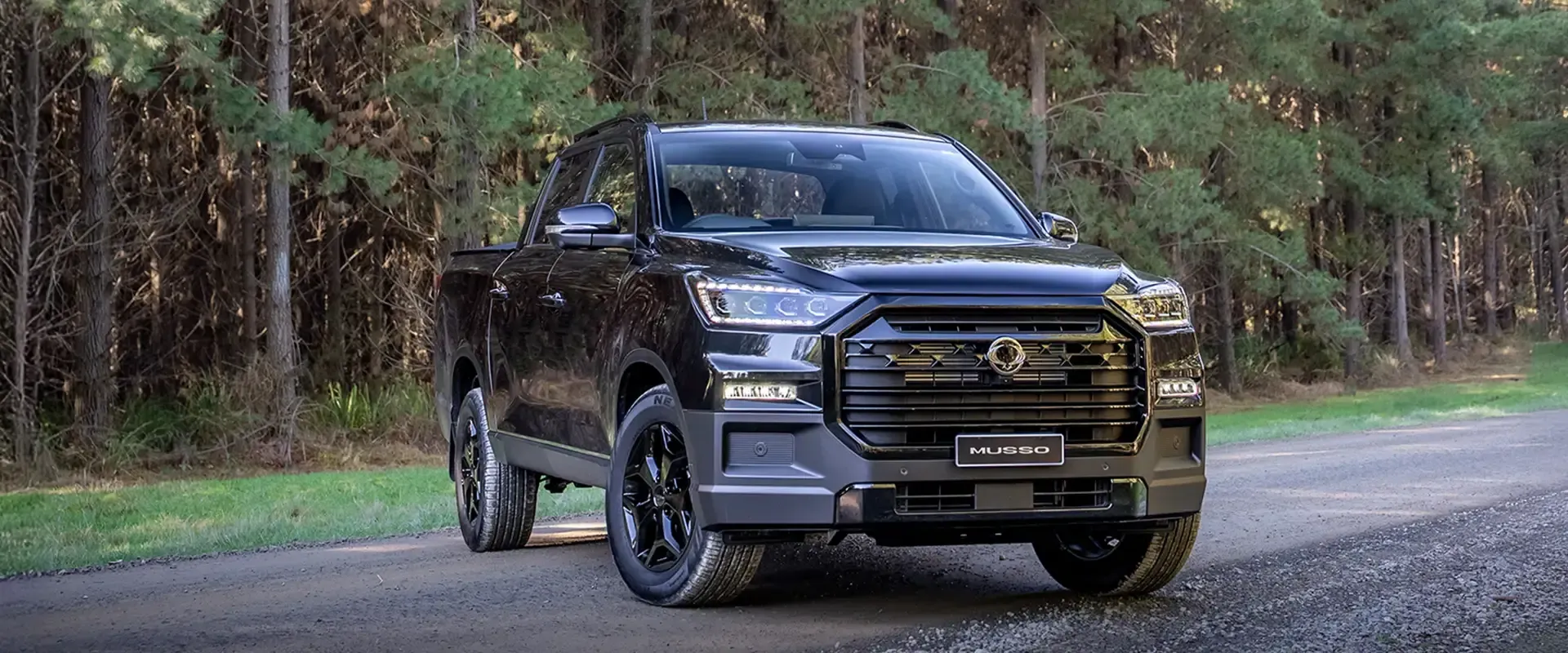 KGM Musso parked on a gravel road