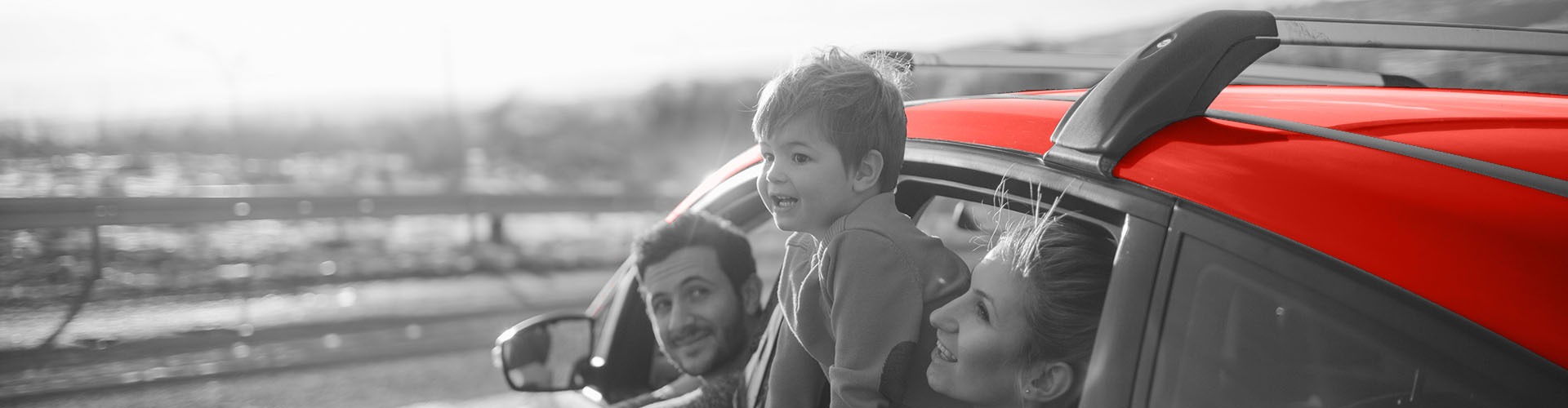 Family inside a car hanging outside the windows