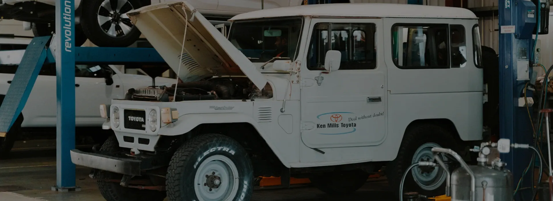 Car with bonnet open in mechanic garage