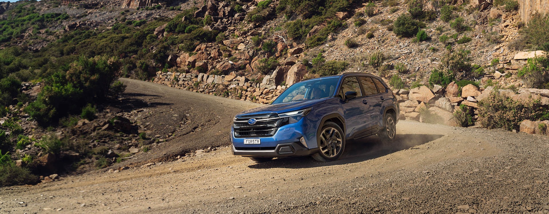 Subaru Forester driving on a dirt road