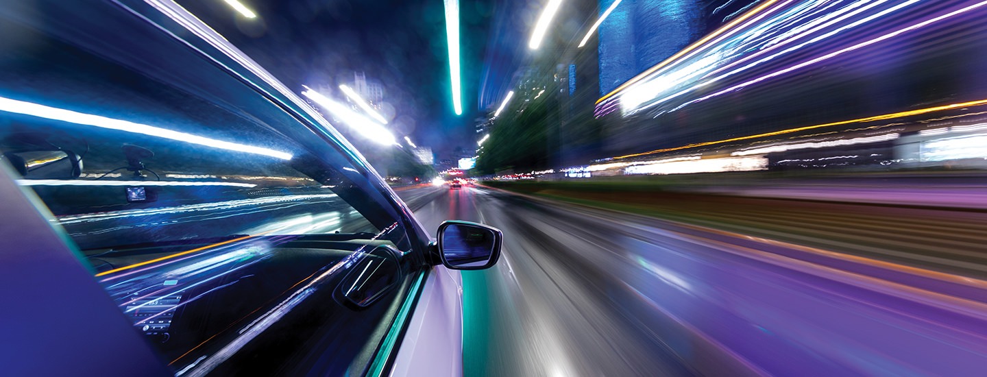 Fast car and city lights indicating speed