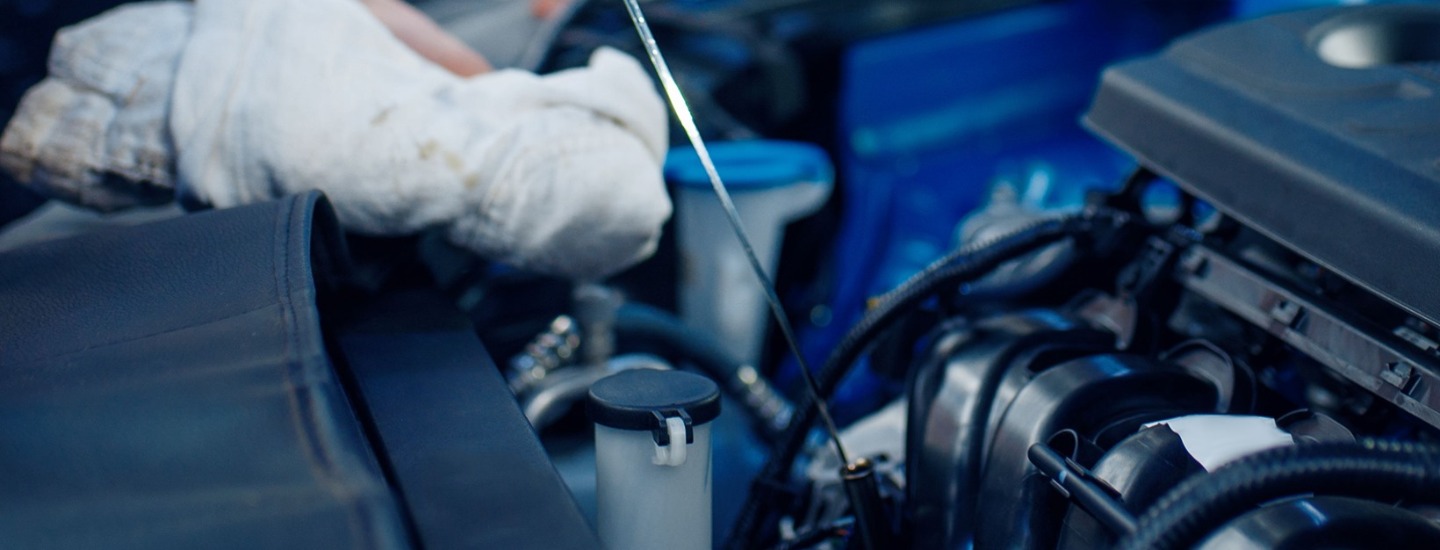 Man pulling out dip stick