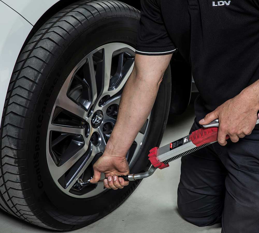 A LDV service technician pumping up the tyre pressure on a LDV vehicle