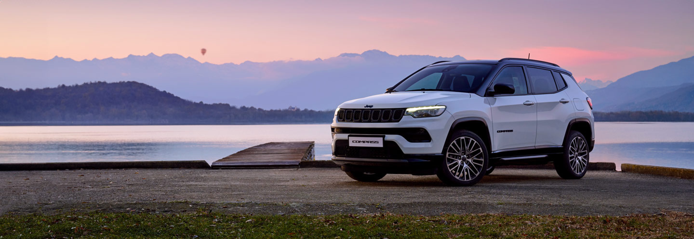 White Jeep Compass by the pier