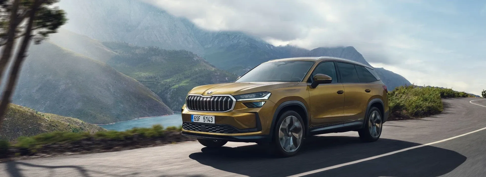 Gold Skoda SUV on mountain road