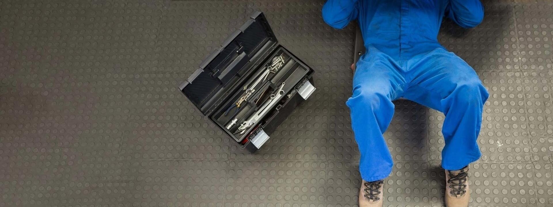 Mechanic servicing vehicle