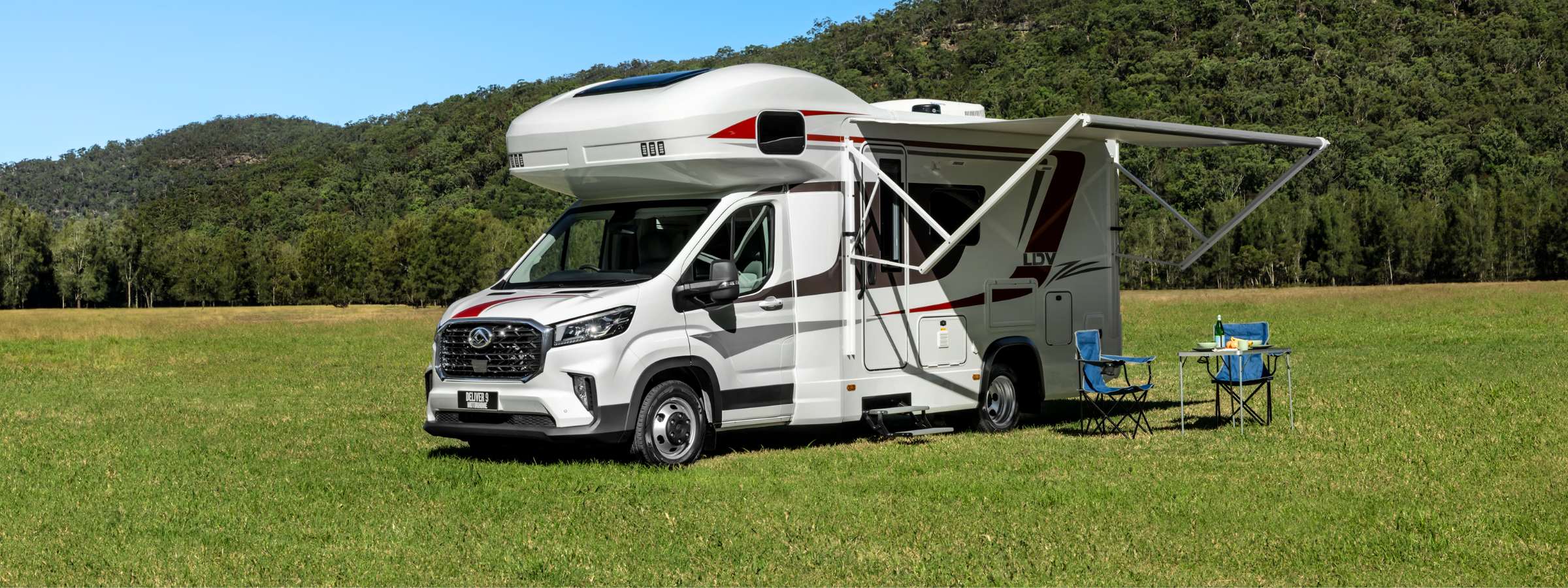 LDV Deliver 9 Motorhome parked outdoors with electric awning extended, set up for outdoor living in Australian bushland