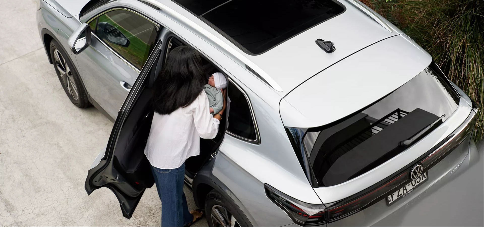Person placing infant in the new Tiguan eHybrid