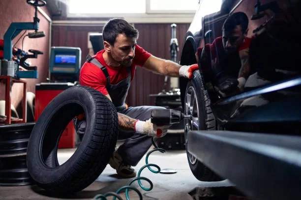 replacing-damaged-car-tire-in-wo.jpg
