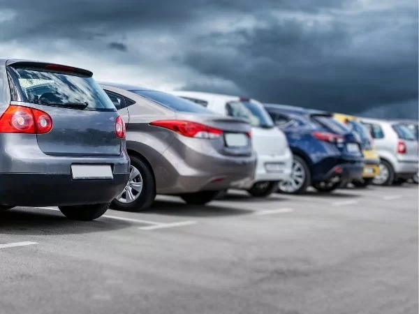 row of different cars in parking lot emphasizing variety