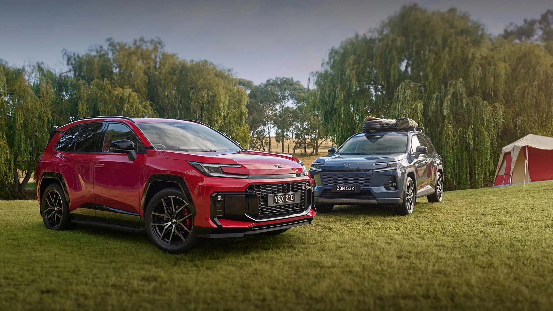 Two RAV4 parked on grass